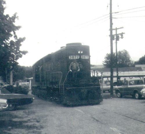 a train is parked on the side of a road